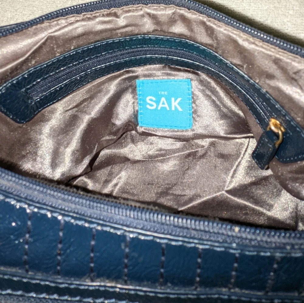 The  Sak navy blue patent leather hobo bag.